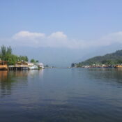 Houseboats and Shikaras on Dal Lake with mountain backdrop in Kashmir