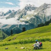 Scenic view of Kashmir Great Lakes trek with snow-capped mountains and grassy meadows