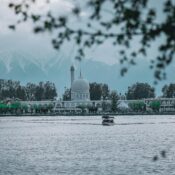Hazratbal Shrine reflected in Dal Lake with mountains in the background