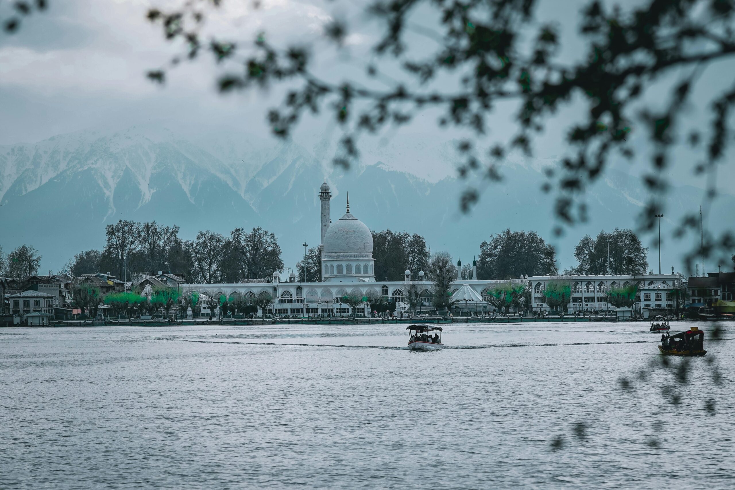 Hazratbal Shrine reflected in Dal Lake with mountains in the background