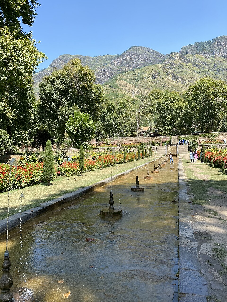 View of Nishat Bagh, a Mughal garden in Srinagar, with terraced lawns, a water canal with fountains and Zabarwan mountains in the background