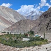 Turtuk village in Nubra Valley with rocky cliffs, green valley and serene landscape.